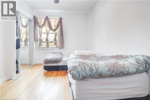 Bedroom with wood finished floors and ceiling fan - 773 Queensdale Avenue E, Hamilton, ON - Indoor Photo Showing Bedroom