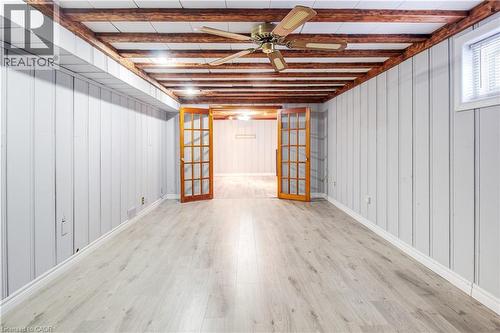 Below grade area featuring french doors, wood finished floors, a ceiling fan, and wood walls - 773 Queensdale Avenue E, Hamilton, ON - Indoor Photo Showing Other Room