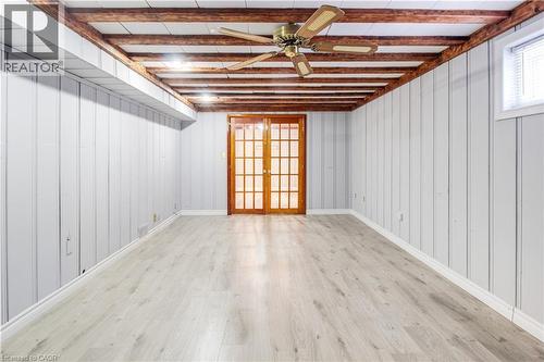 Empty room featuring ceiling fan, light wood finished floors, and french doors - 773 Queensdale Avenue E, Hamilton, ON - Indoor