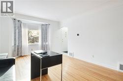 Office with light wood finished floors and arched walkways - 