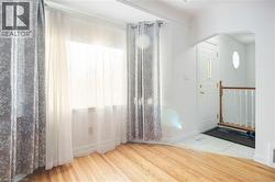 Entrance foyer with arched walkways and light wood finished floors - 