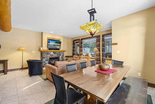 M1-A-1351 Gerry Sorensen Way, Kimberley, BC - Indoor Photo Showing Dining Room With Fireplace