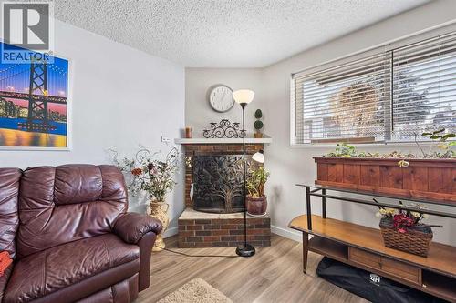 unit 3 fireplace - 11254 6 Street Sw, Calgary, AB - Indoor Photo Showing Living Room With Fireplace