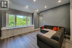 Living area with recessed lighting, light wood finished floors, and vaulted ceiling - 