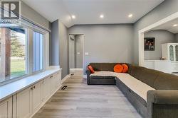 Living room with light wood-style floors and recessed lighting - 