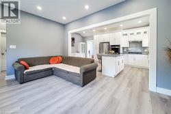 Living area featuring recessed lighting and light wood-style floors - 