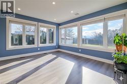 Spare room featuring wood finished floors, healthy amount of natural light, and recessed lighting - 