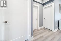 Hall featuring light wood finished floors and washer / clothes dryer - 