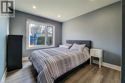 Bedroom featuring wood finished floors and recessed lighting - 