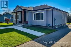 Bungalow with a front lawn and a shingled roof - 