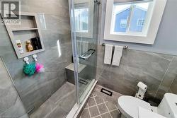 Full bathroom featuring a stall shower and tile walls - 