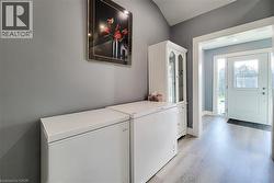 Washroom with light wood-type flooring and baseboards - 