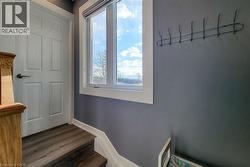 Stairway featuring baseboards and wood finished floors - 