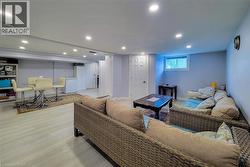 Living area with light wood-style floors and recessed lighting - 