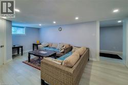 Living room with light wood finished floors and recessed lighting - 