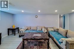 Living area featuring light wood-style flooring and recessed lighting - 