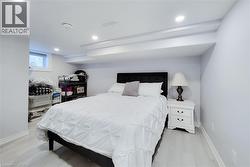 Bedroom with recessed lighting and light wood-style floors - 