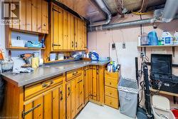 Kitchen with brown cabinetry and open shelves - 