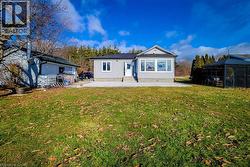 Back of property with a patio, a lawn, a sunroom, and entry steps - 