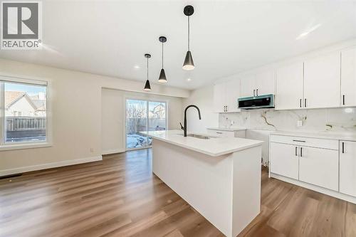 936 Cranston Drive Se, Calgary, AB - Indoor Photo Showing Kitchen With Double Sink