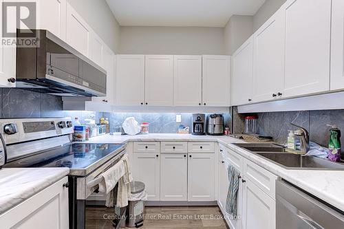 319 - 2511 Lakeshore Road W, Oakville (Br Bronte), ON - Indoor Photo Showing Kitchen With Double Sink