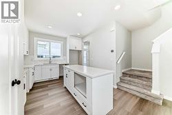 Kitchen & Stairs to Upper Floor • PLEASE NOTE: Kitchen appliances are included, and will be installed prior to possession - 