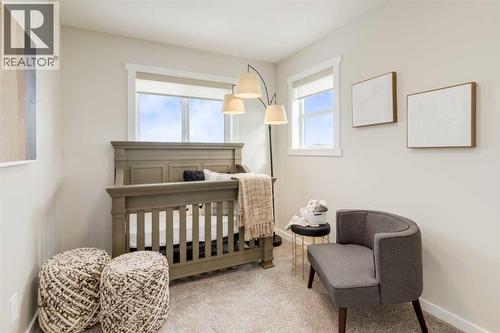 PLEASE NOTE: Photos are of a finished Showhome of the same model – fit and finish may differ on finished spec home. Interior selections and floorplans shown in photos - 154 Bartlett Crescent Se, Calgary, AB - Indoor Photo Showing Bedroom