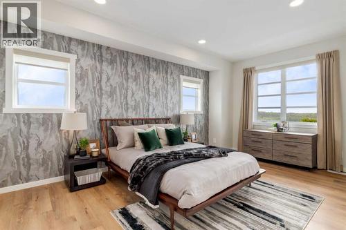 PLEASE NOTE: Photos are of a finished Showhome of the same model – fit and finish may differ on finished spec home. Interior selections and floorplans shown in photos - 154 Bartlett Crescent Se, Calgary, AB - Indoor Photo Showing Bedroom