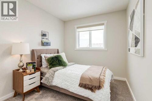 PLEASE NOTE: Photos are of a finished Showhome of the same model – fit and finish may differ on finished spec home. Interior selections and floorplans shown in photos - 154 Bartlett Crescent Se, Calgary, AB - Indoor Photo Showing Bedroom