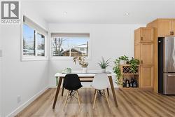 Dining space with light flooring and recessed lighting - 