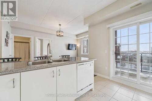 321 - 1440 Gordon Street, Guelph (Pineridge/Westminster Woods), ON - Indoor Photo Showing Kitchen With Double Sink