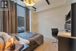 Bedroom with light wood-type flooring and a desk - 