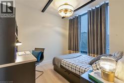 Bedroom with light wood-style flooring and a desk - 