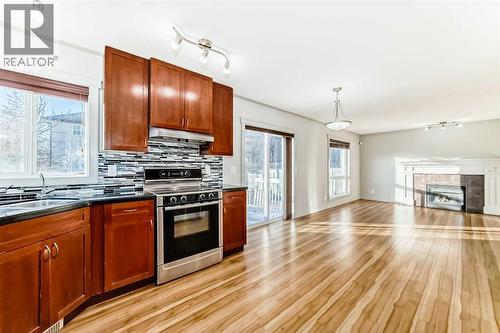 1156 Sherwood Boulevard Nw, Calgary, AB - Indoor Photo Showing Kitchen With Fireplace With Double Sink