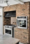Brick accents, gas stove, built-in microwave. - 