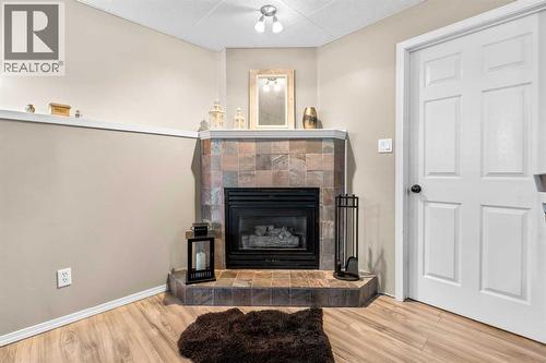 Fireplace in the basement - 6 Easterbrook Place Se, Airdrie, AB - Indoor Photo Showing Living Room With Fireplace