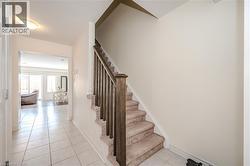 Stairway featuring tile patterned floors and baseboards - 