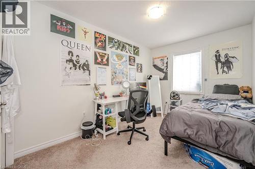 Carpeted bedroom featuring baseboards and an office area - 23 Kingsbury Square Unit# 23, Guelph, ON - Indoor Photo Showing Bedroom