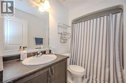 Bathroom with vanity and curtained shower - 