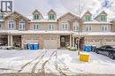 View of front facade featuring an attached garage, stone siding, and covered porch - 23 Kingsbury Square Unit# 23, Guelph, ON  - Outdoor With Facade 