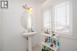 Half bathroom with baseboards and light tile patterned floors - 