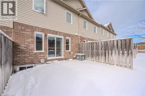 Snow covered property with brick siding - 23 Kingsbury Square Unit# 23, Guelph, ON - Outdoor With Exterior