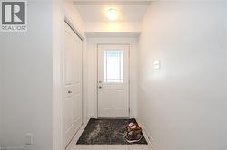 Doorway with baseboards and tile patterned flooring - 