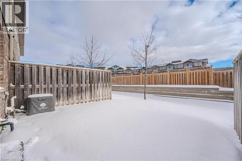 Fenced backyard with a residential view and a wooden deck - 23 Kingsbury Square Unit# 23, Guelph, ON - Outdoor