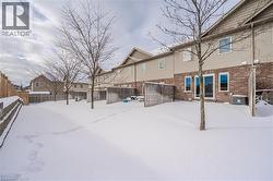 Yard covered in snow featuring a fenced backyard and a residential view - 