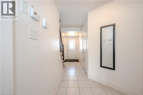 Corridor with light tile patterned floors and baseboards - 23 Kingsbury Square Unit# 23, Guelph, ON - Indoor Photo Showing Other Room