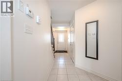 Corridor with light tile patterned floors and baseboards - 