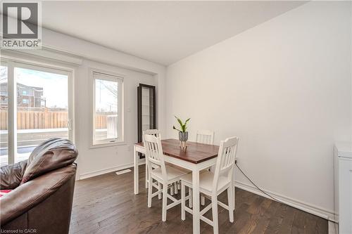 Dining room with dark wood-style floors and baseboards - 23 Kingsbury Square Unit# 23, Guelph, ON - Indoor Photo Showing Dining Room