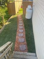 Synthetic turf with walkway side door to backyard - 