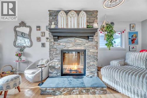 708 Allden Place Se, Calgary, AB - Indoor Photo Showing Living Room With Fireplace